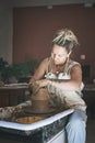 A day without art is a day wasted. a young woman working with clay in a pottery studio. Royalty Free Stock Photo