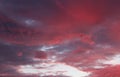 Pretty red and purple skies at daybreak, with large puffy clouds opening up for the sunny day ahead