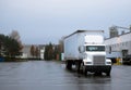 Day cab semi truck trailer on warehouse parking lot Royalty Free Stock Photo