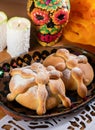 Day of the Dead altar. Mexican tradition. Pan de muerto, bread of dead, candles and skull. AI generated