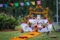 Altar of the dead with flowers and food, perched on grass and plants Royalty Free Stock Photo