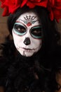 Day of the dead. Halloween. Young woman in day of the dead mask skull face art and rose. Dark background. Royalty Free Stock Photo