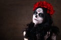 Day of the dead. Halloween. Young woman in day of the dead mask skull face art and rose. Dark background. Royalty Free Stock Photo