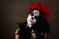 Day of the dead. Halloween. Young woman in day of the dead mask skull face art and rose. Dark background. Royalty Free Stock Photo