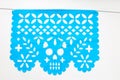 Day of the Dead, Papel Picado with a skull head, blue traditional Mexican paper cutting flag.