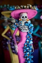 Day of the Dead. Statuette of a woman - female skeleton- with a pink dress. Royalty Free Stock Photo