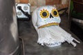 Day of the Dead straw dispenser on counter with plastic paper wrapped straws in mouth opening