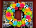 Day of the Dead wreath on door with tree and neighborhood reflected in beveled glass window Royalty Free Stock Photo