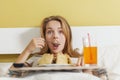 Day gluttony, teen girl eating a cake and drinks soda