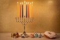 Day 7 of jewish  Hanukkah with traditional chandelier menorah, spinning top toys dreidels and a doughnut and ch Royalty Free Stock Photo