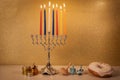 Day 6 of jewish holiday Hanukkah with traditional chandelier menorah, spinning top toys dreidels and a doughnut and ch Royalty Free Stock Photo