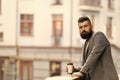 The day just started. Businessman in hipster style holding takeaway coffee. Hipster with paper cup walking in city Royalty Free Stock Photo