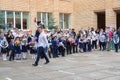 On the day of Knowledge on September 1, a high school student carries a first-grader in his arms, with a bell, the first bell ring