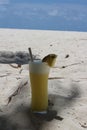 A day in the Maldives, a glass of freshly squeezed pineapple juice with white foam, an inserted straw and a piece of pineapple on Royalty Free Stock Photo