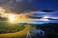 day and night time change concept above road through meadow in mountains Royalty Free Stock Photo