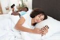 Day off in bed, gadget addiction and couple problems due social media online Royalty Free Stock Photo