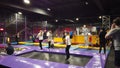 A day off, a crowd of children and parents having fun jumping on trampolines