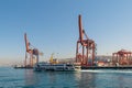 Day shot of the cranes in the shipyard of the Port of Haydarpasha, and passing ferry boat with background view of Istanbul, Turkey