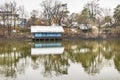 A beautiful house covered with snow in the middle of the river with reflections.Cold day moody sky Royalty Free Stock Photo