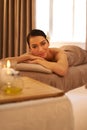 A day to recharge and repair. A beautiful young woman relaxing on a massage table before her massage.