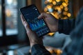 Day trader using trading app on smartphone checking stock market data Royalty Free Stock Photo