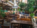 Day view of the empty traditional outdoor seating area of taverns with colorful chairs, tables and vintage decoration