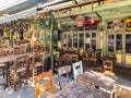 Day view of the empty traditional outdoor seating area of taverns with colorful chairs, tables and vintage decoration