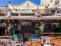 Day view of the empty traditional outdoor seating area of taverns with colorful chairs, tables and vintage decoration