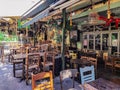 Day view of the empty traditional outdoor seating area of taverns with colorful chairs, tables and vintage decoration