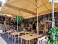 Day view of the empty traditional outdoor seating area of taverns with colorful chairs, tables and vintage decoration