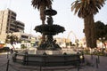 day view of the Ornamental Pile, -water fountain with bronze sculptures in the background Cathedral of Tacna Peru