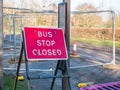 Day view sign informing about roadworks next to bus stop on UK road Royalty Free Stock Photo