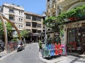 Thessaloniki, Greece Empty outdoors tables with colorful wooden chairs stacked outside.