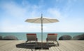 Daybed with umbrella on wooden terrace at sea view