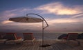 Daybed with umbrella on wooden terrace at twilight sea view,