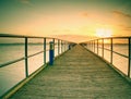 lDaybreak morning wooden dock & x28;pier& x29; orange sea and clear sky Royalty Free Stock Photo