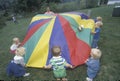 Daycare children playing a parachute game