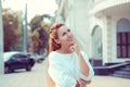 Daydream. Happy woman smiling looking up at copy space above hand, thinking, daydreaming hand on cheek, street background with Royalty Free Stock Photo