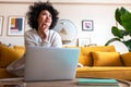 Daydreaming. African American woman using laptop working at home living room thinking. Copy space. Royalty Free Stock Photo