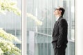 Daydreaming Businessman looking through the window Royalty Free Stock Photo