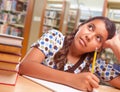 Daydreaming Hispanic Girl Student with Pencil and Books Studying