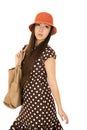 Daydreaming teen female model wearing a brown polka dot dress an Royalty Free Stock Photo
