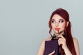 Daydreaming thinking about a romance. Closeup clever brunette woman reading book having thought isolated on light green grey wall Royalty Free Stock Photo