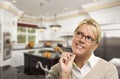 Daydreaming Woman with Pencil Inside Beautiful Custom Kitchen