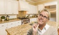 Daydreaming Woman with Pencil Inside Beautiful Custom Kitchen Royalty Free Stock Photo