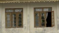 A house facade with glass windows in wooden frames