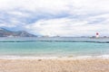 Daylight cloudy day view to beachline with ships cruising on water Royalty Free Stock Photo