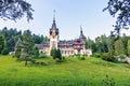 Daylight far view to Peles castle front facade with hanging flag Royalty Free Stock Photo