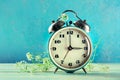 Daylight Saving Time concept, spring forward. A vintage alarm clock Royalty Free Stock Photo