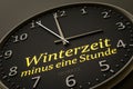 Daylight saving winter time minus one hour modern black clock style Royalty Free Stock Photo